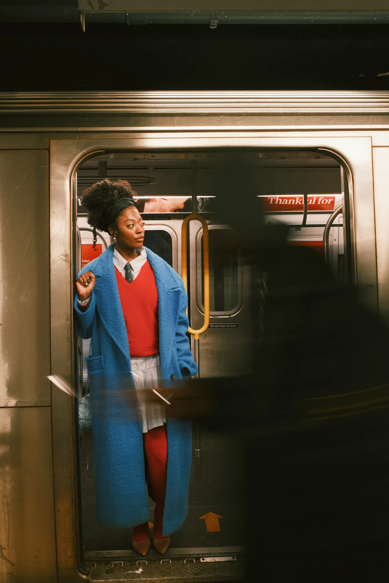 A character stepping through subway doors mid movement act