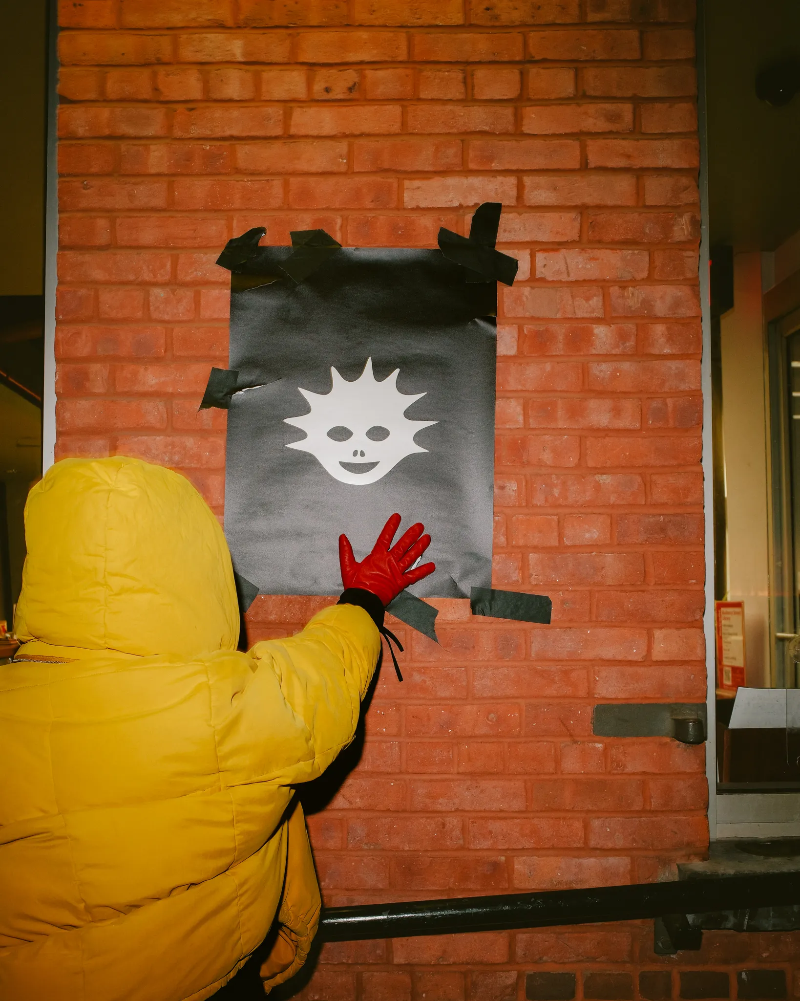 Cast member beside the campaign symbol poster